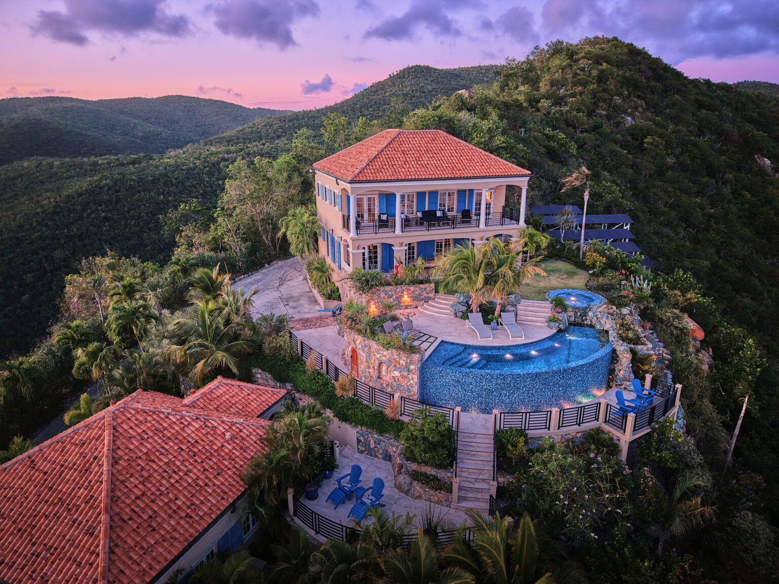 Aerial view of a hillside villa with terraced pool and spa built into the slope, private estate St. John USVI, by Aquatics International Group